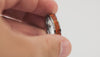 Video showing the Gunmetal Tungsten Ring rotating, detailing the bright orange fire opal inlay and silver flakes.